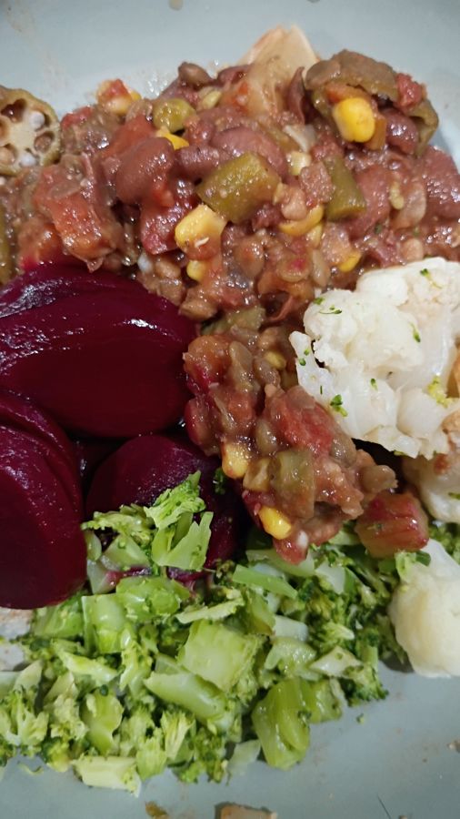 A plate with the bean and lentil stew, broccoli, cauliflower and deep red beets